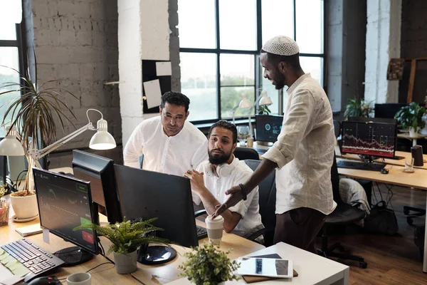 Three intercultural businessmen consulting about working moments — Stock Photo, Image