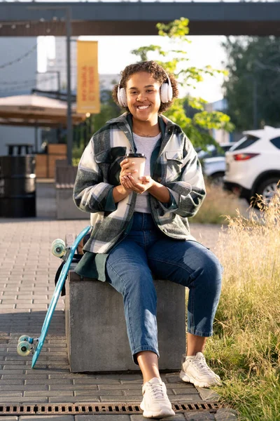 Glückliche Skateboarderin mit Kopfhörern — Stockfoto
