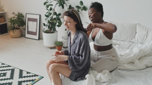 Handheld Slowmo Tracking Happy African American Woman Sitting Bed Brushing — Stock Video