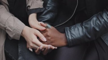 Dışarıda el ele tutuşan tanınmayan lezbiyen çiftin orta bölüm fotoğraflarını çek.