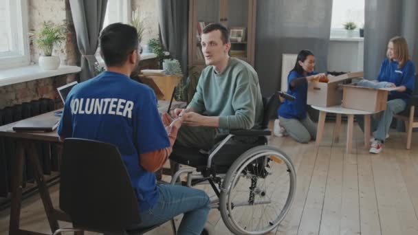 Tracking Slowmo Shot Team Volunteers Helping Man Disability House Setting — Stock Video