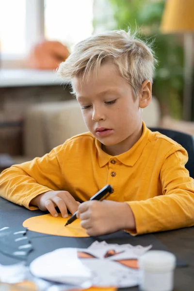 Netter kleiner Junge zeichnet Bild von Halloween-Symbol — Stockfoto
