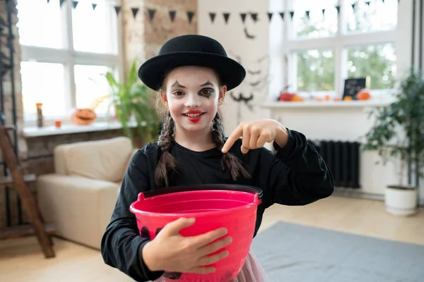 Happy girl in black attire asking for halloween treats — Stock Photo, Image