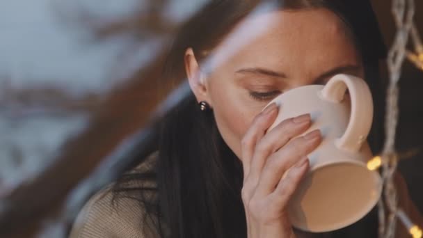 Handheld Close Slowmo Beautiful Woman Drinking Tea Looking Out Window — Stock Video