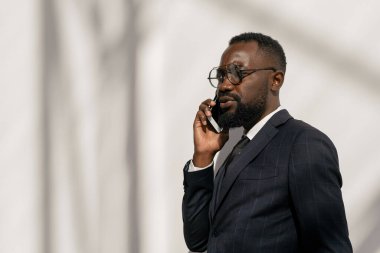 Cep telefonundan konuşan kendine güvenen genç bir broker.