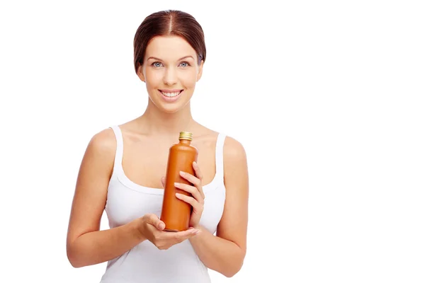 Woman presenting body lotion — Stock Photo, Image