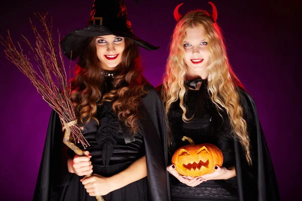 Two women with broom and pumpkin — Stock Photo, Image