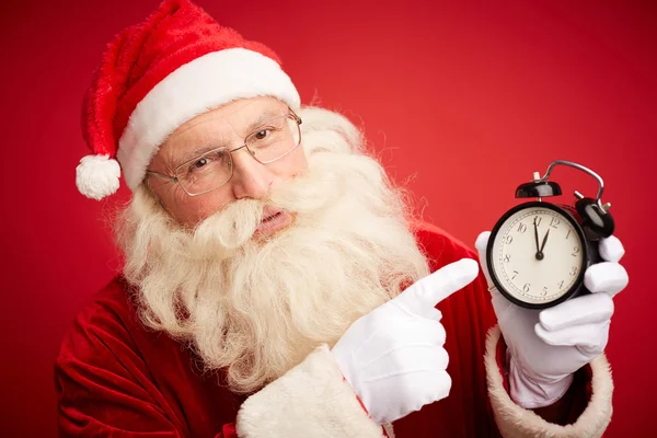 Santa claus pekar på klockan — Stockfoto