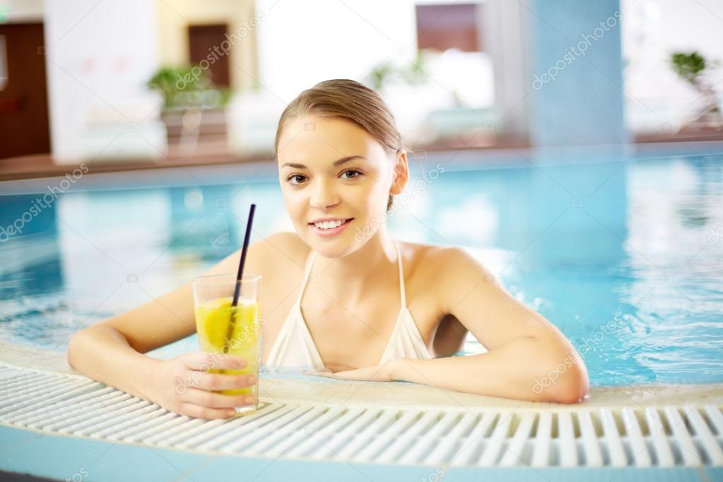 Pretty girl relaxing in swimming pool