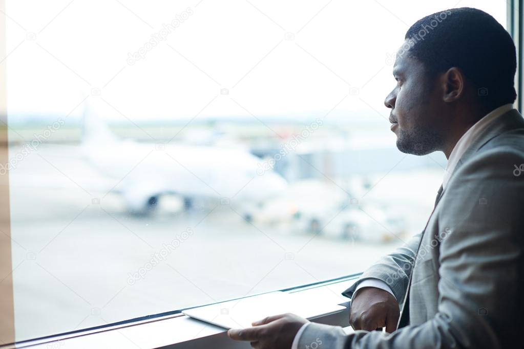 Businessman with digital tablet in airport
