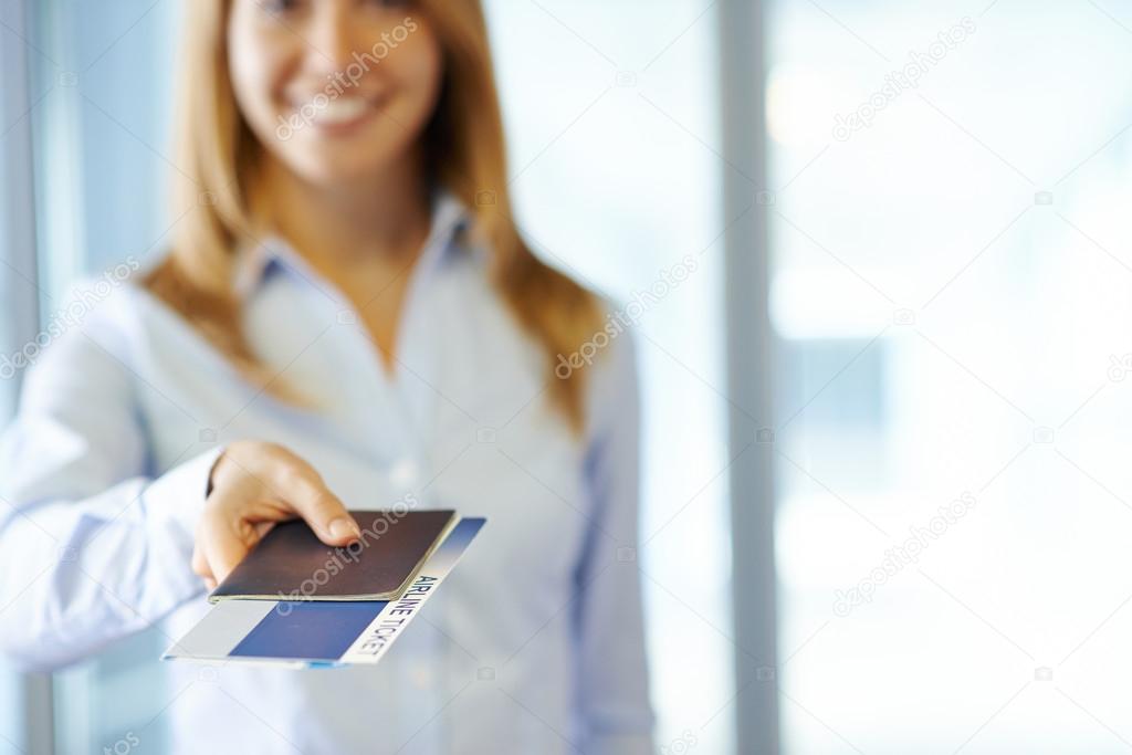Woman giving passport and air ticket