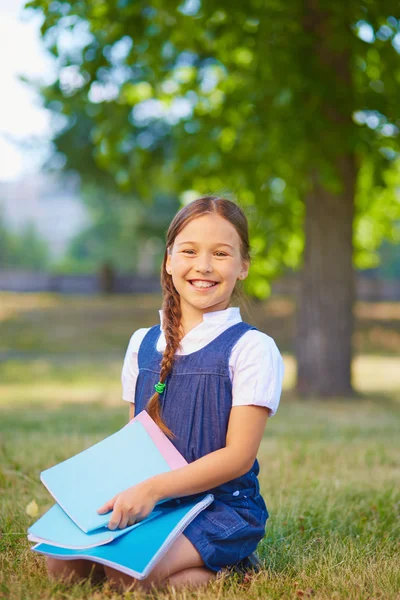 Schoolgirl with copybooks — Stock Photo, Image