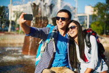 Traveling young couple taking selfy