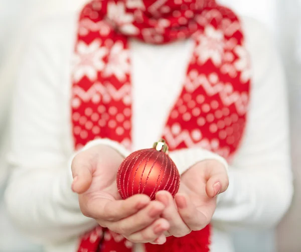 Xmas toy ball on hands — Stock Photo, Image