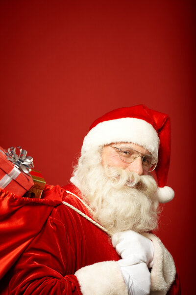 Santa Claus carrying sack with gifts