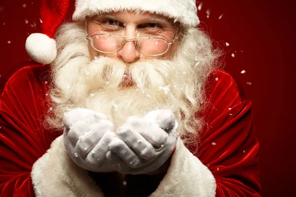 Santa Claus blowing snow Stock Image