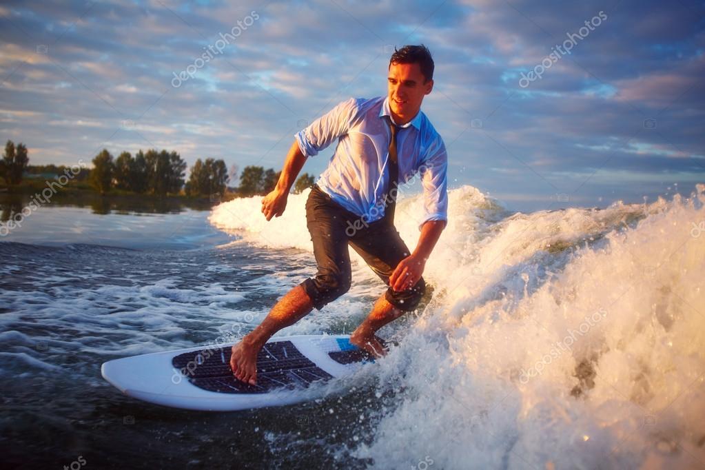 Man surfing in the sea Stock Photo by pressmaster 55491989