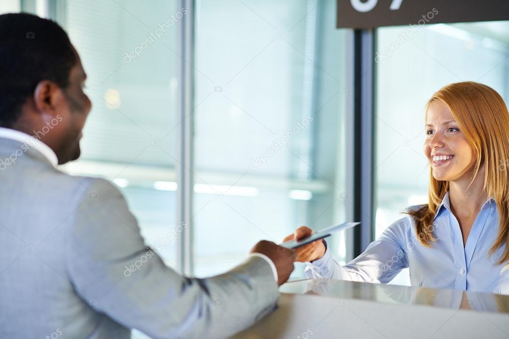 Woman giving ticket to businessman