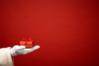 Santa  hand holding red box clipart