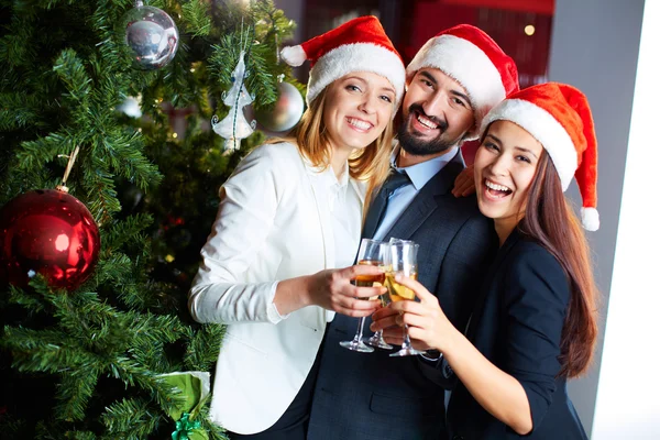 Co-workers in Santa caps — Stock Photo, Image