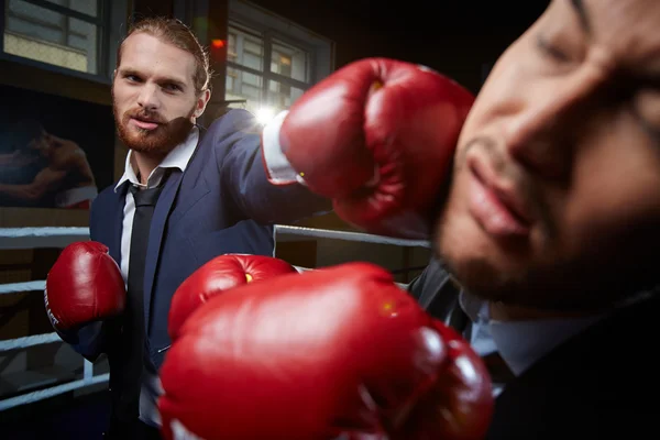 Businessman hitting his rival — Stock Photo, Image