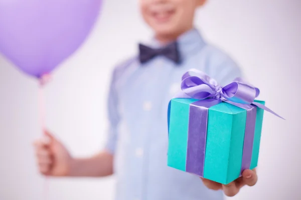 Little boy holding present and  balloon — Stock Photo, Image