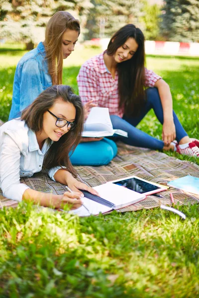 Nastoletnich kobiet robienia notatek w parku — Zdjęcie stockowe