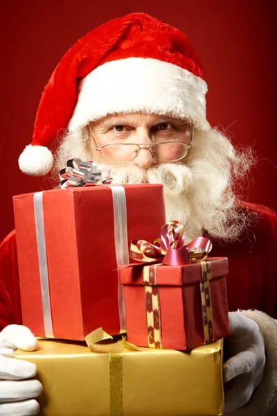 Santa Claus with pile of gifts — Stock Photo, Image