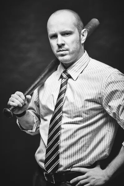 Businessman carrying baseball bat — Stock Photo, Image