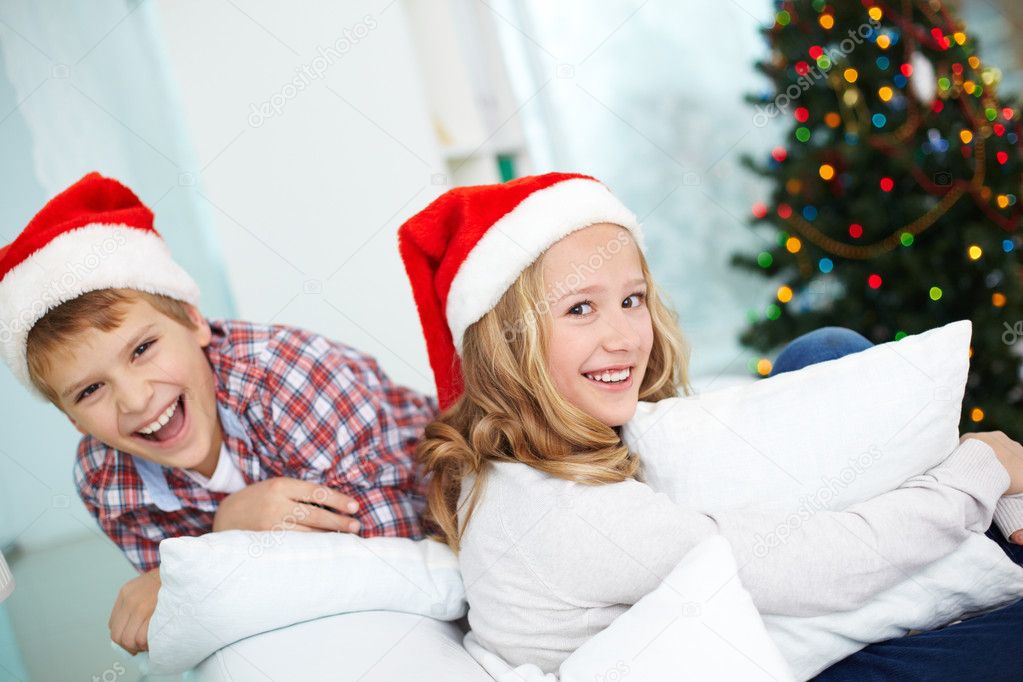 Sister and  brother in Santa caps