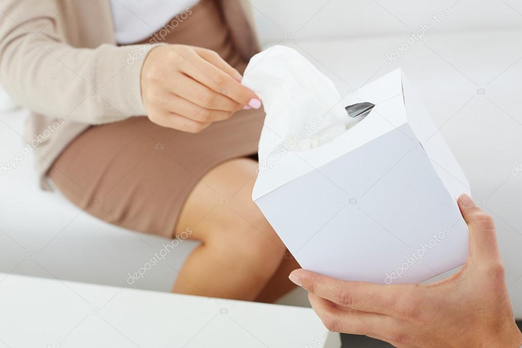 Patient hand taking paper tissue