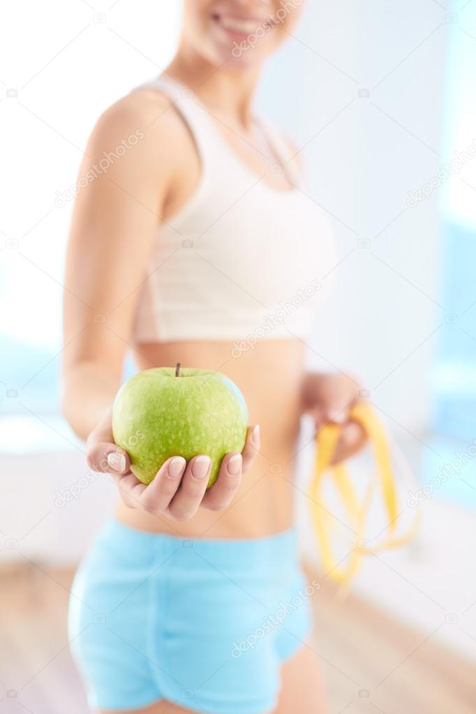 Woman holding green apple