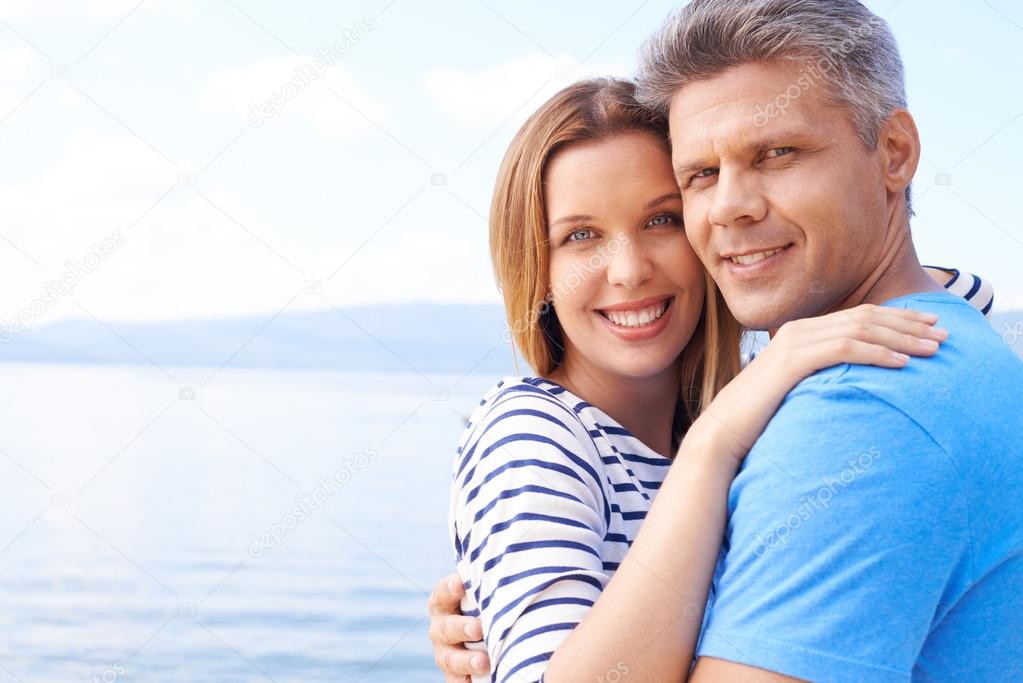 Couple embracing near water