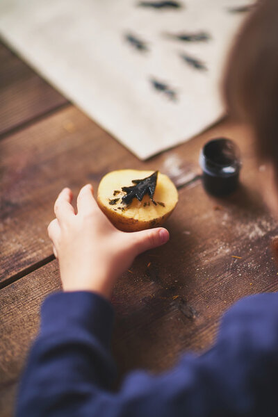 Boy practicing potato printing