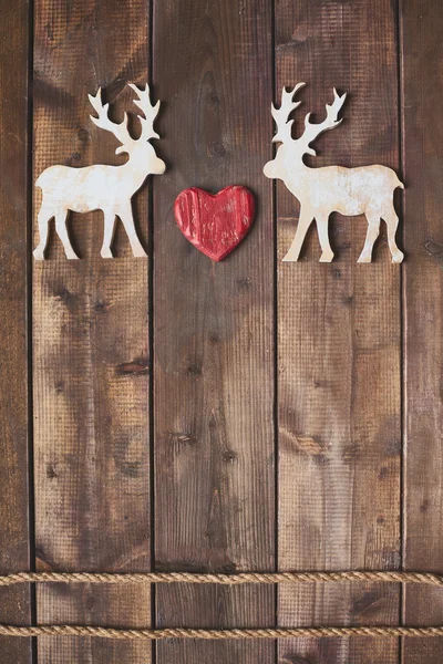 Wooden deer with red heart — Stock Photo, Image
