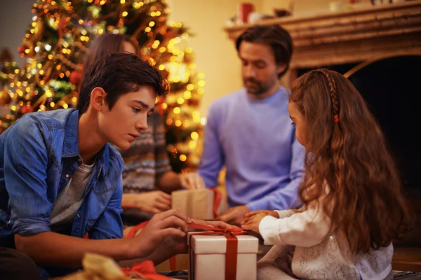 Brother and sister unpacking gift box — Stock Photo, Image