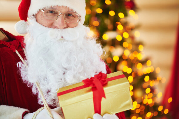 Santa Claus holding golden giftbox