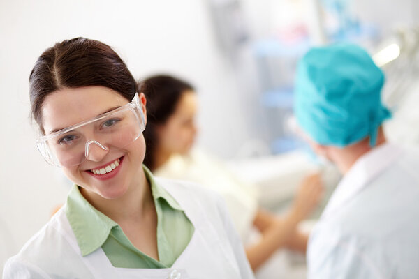 Doctor assistant in protective eyeglasses