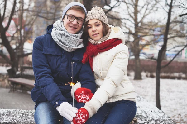 Young couple with Bengal ligh — Stock Photo, Image