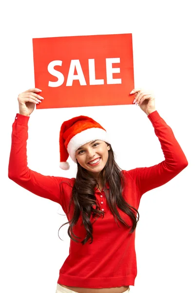 Girl in Santa cap showing red sale card — Stock Photo, Image