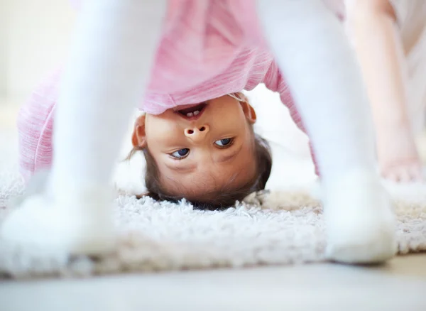Little girl somersaulting — Stock Photo, Image