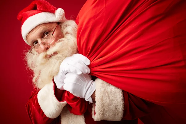 Santa Claus with huge  red sack Royalty Free Stock Photos