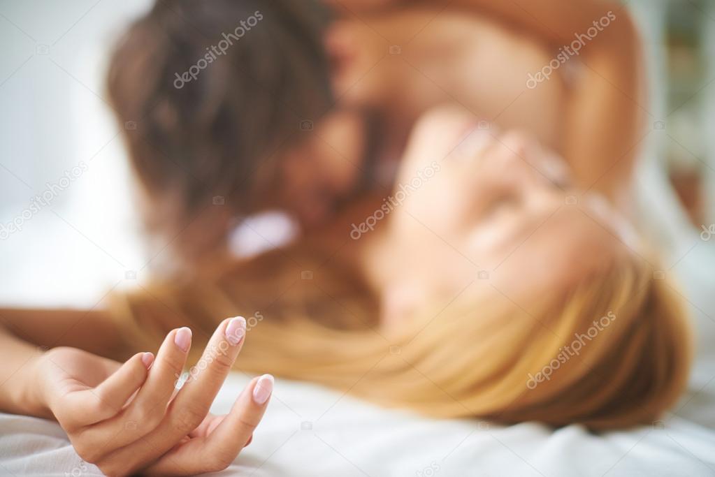 Couple kissing in bed