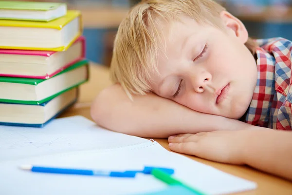 Schoolboy napping on desk — Stock Photo, Image