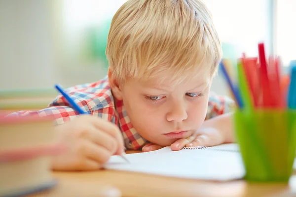 Bored pupil sitting at lesson Stock Photo