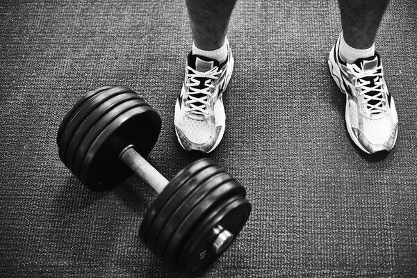 Man in sneakers and barbell