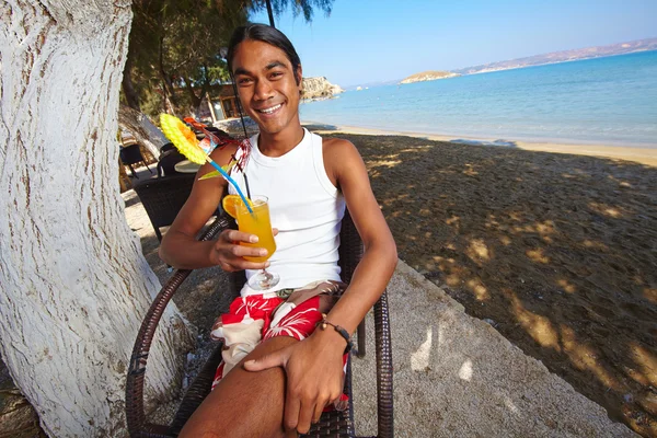 Latino man with glass of juice — Stock Photo, Image