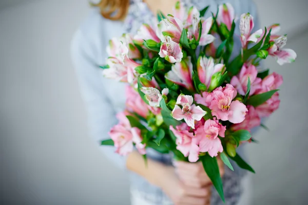 Lilies in female hands — Stock Photo, Image