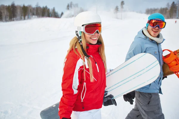 Girl and boyfriend with  snowboards Stock Image