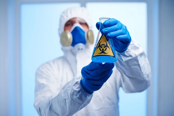 Scientist holding flask with toxic fluid — Stock Photo, Image